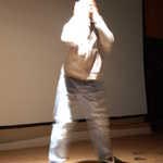 Street
performance in white costume that blurs as he spins