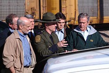 Secretary Chertoff and President Bush review a map with Deputy chief Patrol Agent Paul Besson during a tour of the El Paso Sector of the U.S.-Mexican border region.