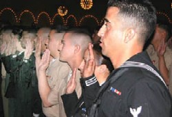 Member of the armed services are sworn in during a citizenship ceremony. (Photo USCIS)